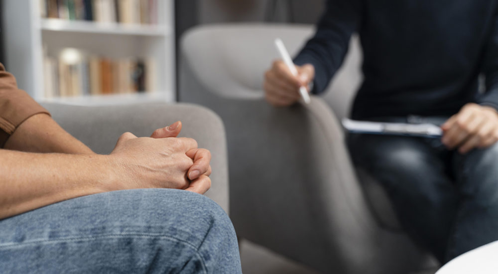 woman-with-hands-together-talking-with-counselor woman-with-hands-together-talking-with-counselor